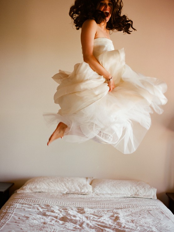 Bride jumping on bed, wedding night