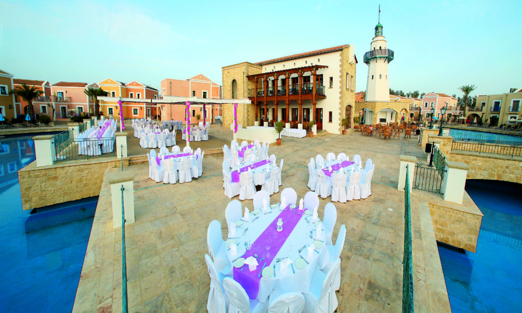 Wedding reception in Cyprus with TUI. Pink. White. Tables and Chairs. Waterfront.