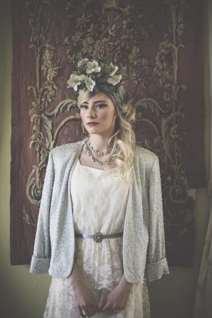 Bride with floral crown. Dress and Jacket. Belt with Brooch.