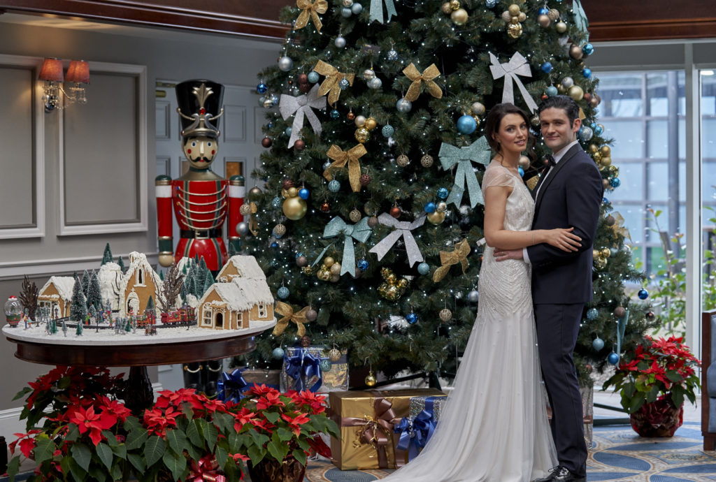 Bride and Groom standing at the Christmas tree at Johnstown Estate