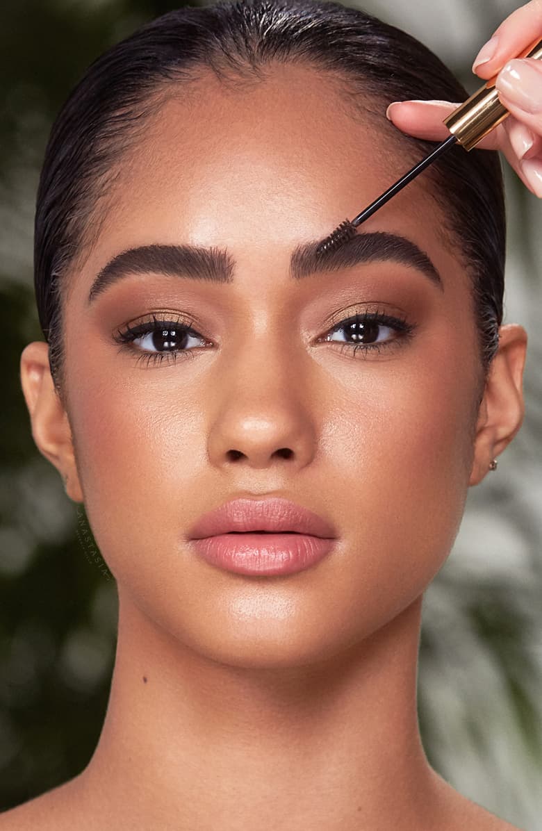 Model having pomade applied to her brows.