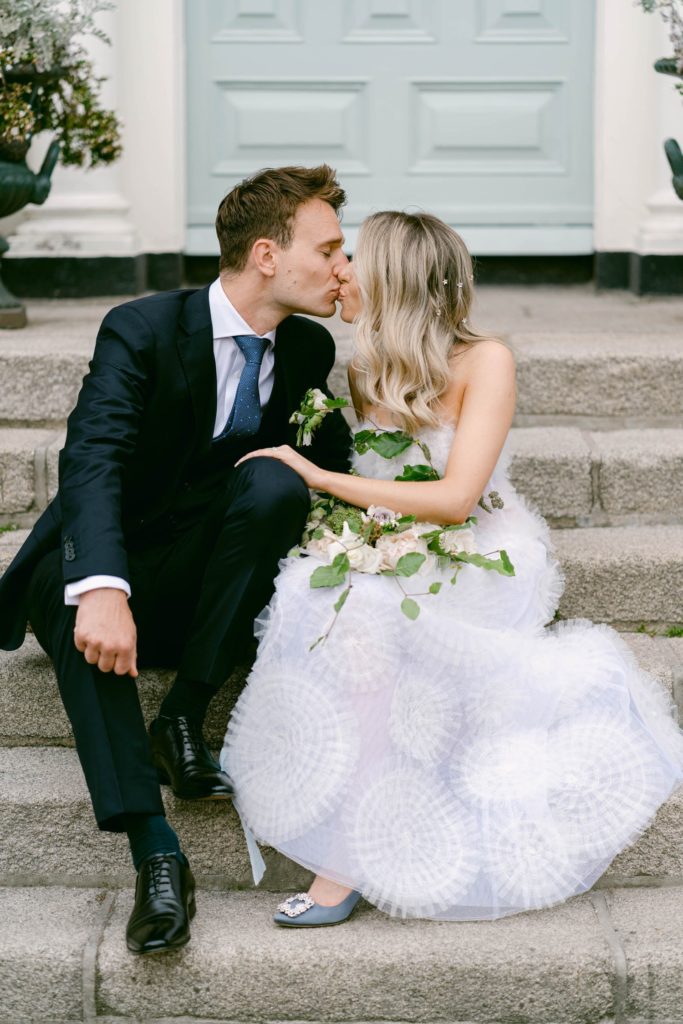 Irish bride and groom kissing outside of wedding venue in Dublin, Ireland