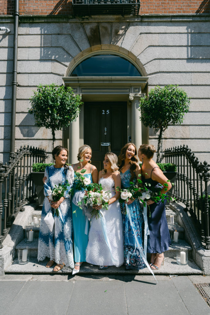 Irish bride and her bridesmaids standing on the steps of Number 25 Fitzwilliam in Dublin