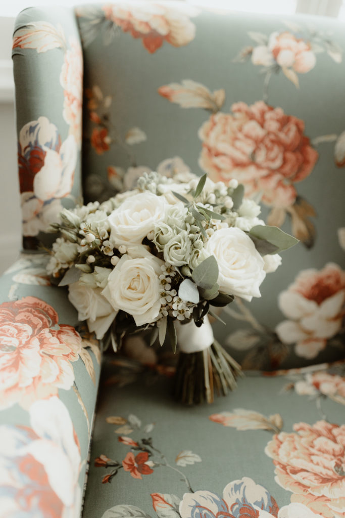 White flowers sitting on a blue and pink chair