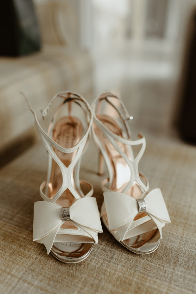 White leather ted baker high heel with a large bow on the front