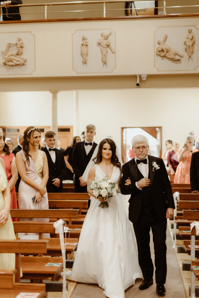 Irish bride and father of the bride walking down the aisle of an Irish church