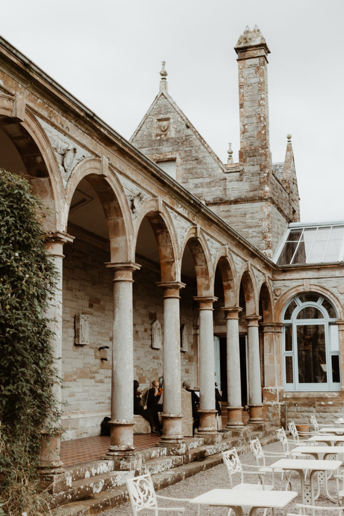 Grey stone building in Castle Leslie estate in Ireland with a string quartet inside