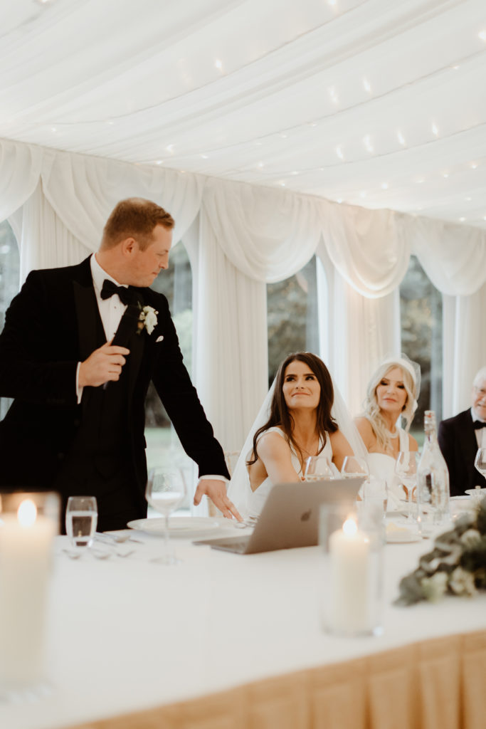 Irish Bride and groom sitting at their wedding table looking into each-others eyes during the groom speech