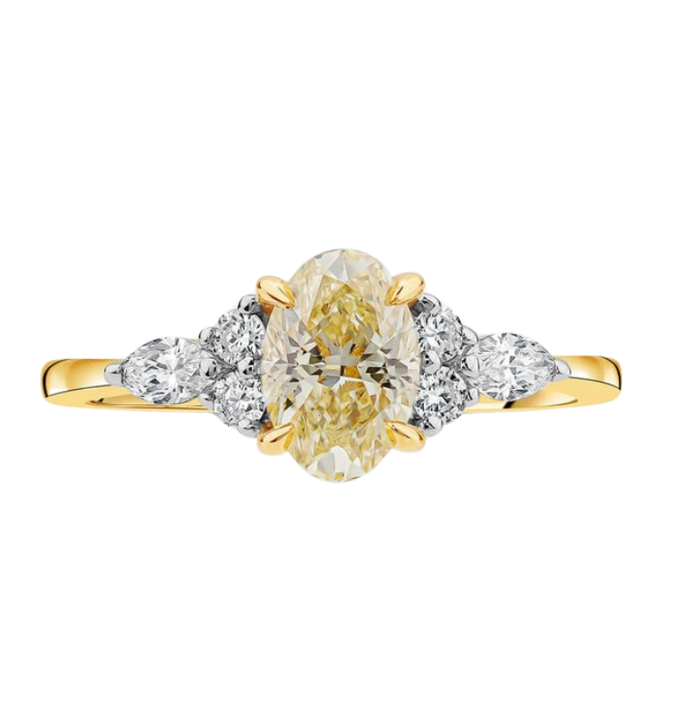 Yellow gold engagement ring with a large oval cut yellow citrine centre stone and three white diamond clusters on either side